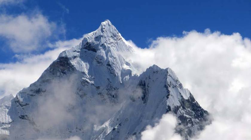 Awesome rocky giant soared above blue sky and white clouds!