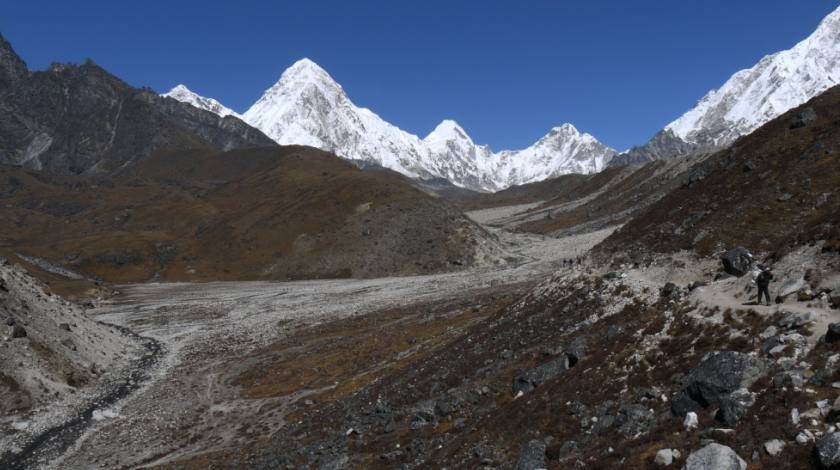 Enjoying awesome mountains while walking through barren landscapes